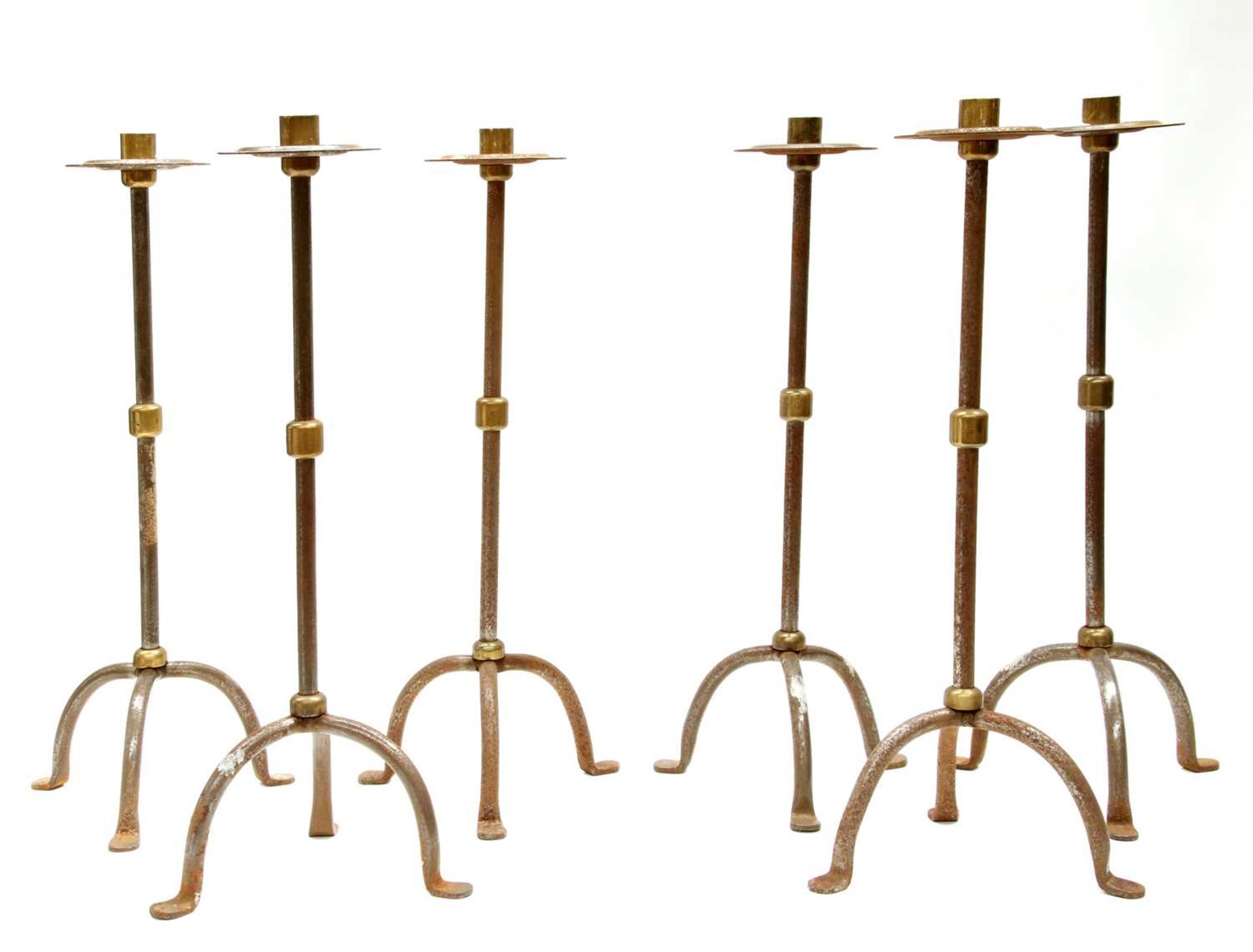 A set of six steel and brass candlesticks