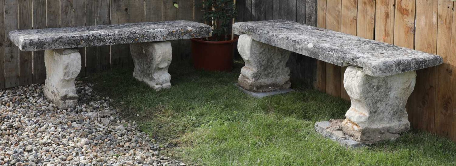 A near pair of carved limestone garden seats