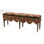 A Victorian ebonised and needlework upholstered stool
