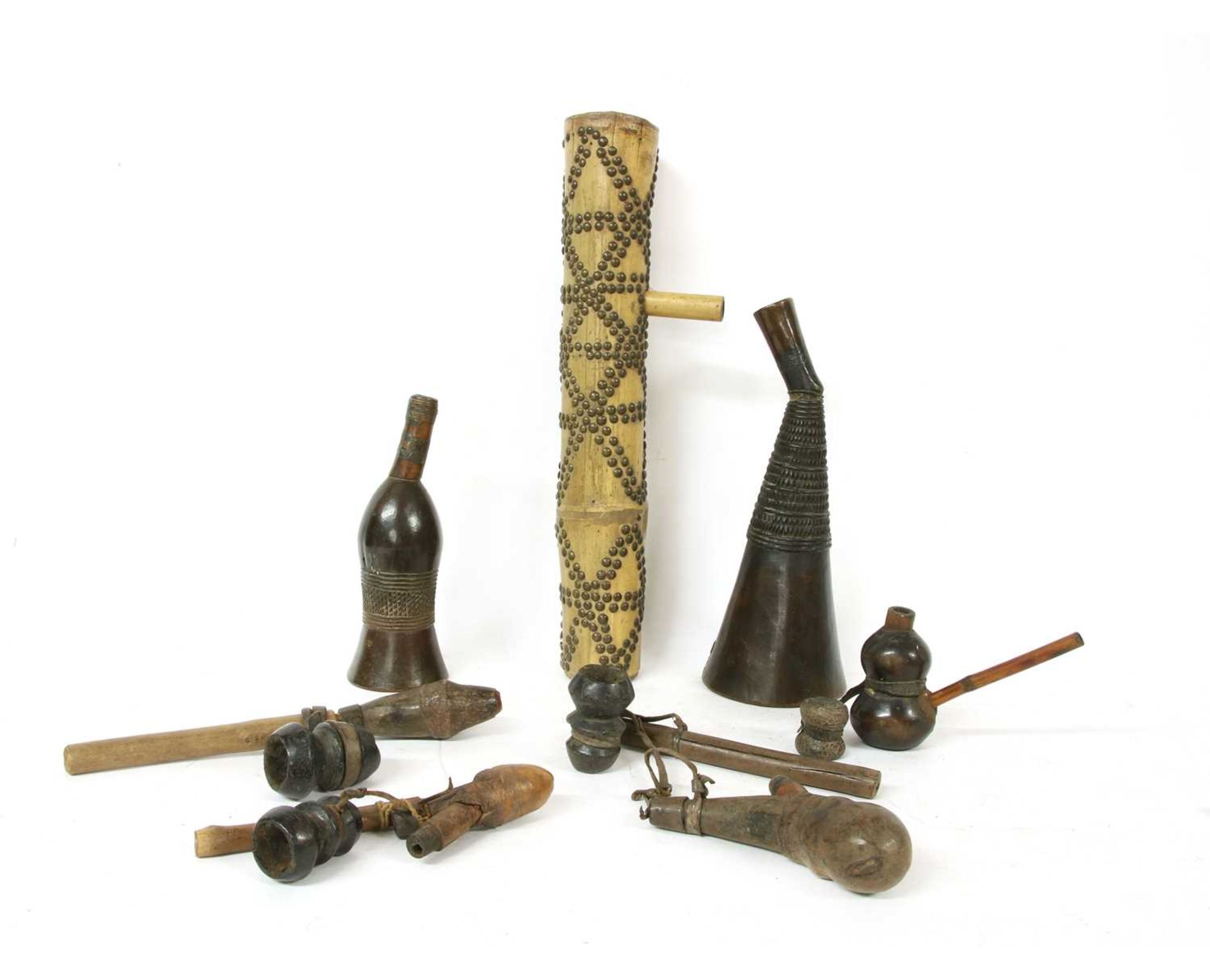 Four African section wood and leather mounted water pipes,