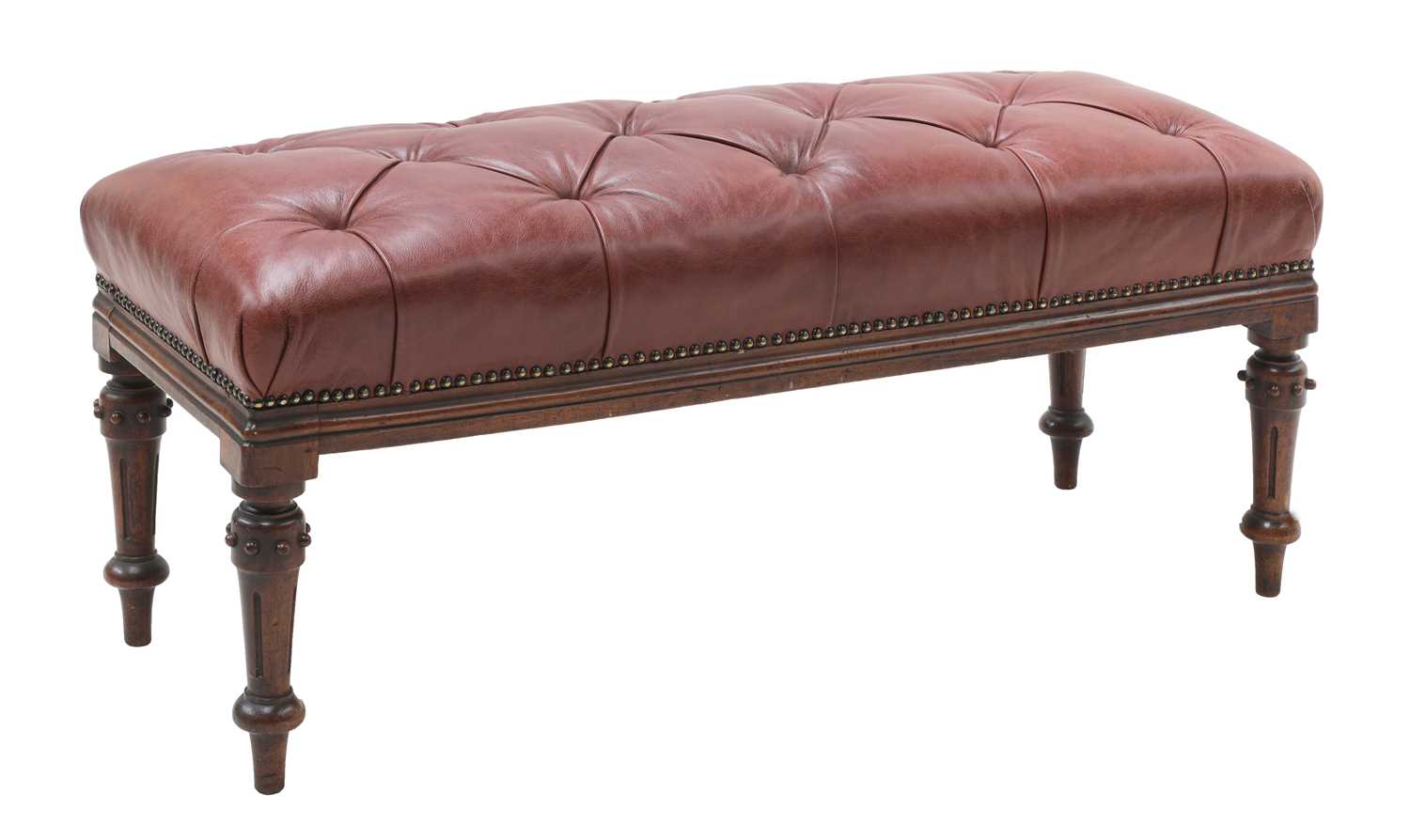 A long buttoned leather upholstered stool,