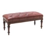 A long buttoned leather upholstered stool,