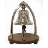 A large brass ship's bell on stand,