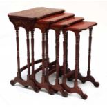 A nest of four red lacquer occasional tables,