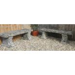 A pair of weathered composite stone garden benches,