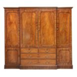 A Regency mahogany, crossbanded and strung breakfront triple wardrobe