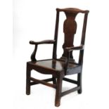 A substantial oak country open armchair,