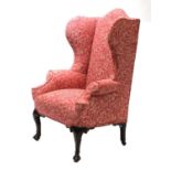 A mahogany wingback armchair