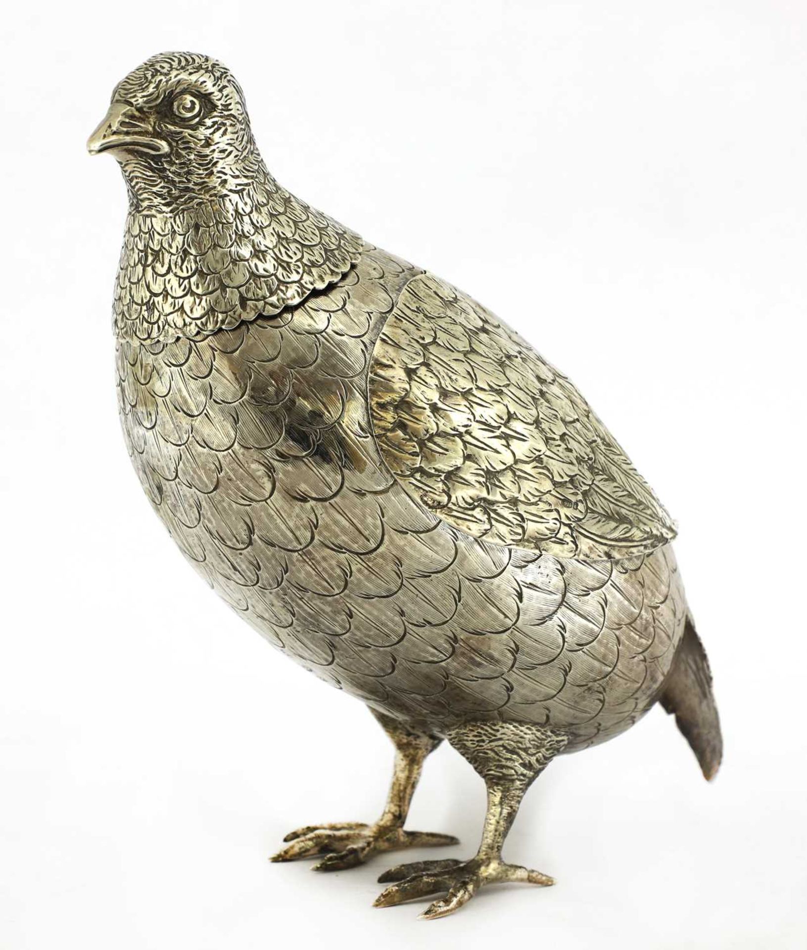 A large silver model of a partridge,