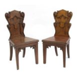 A pair of Victorian oak Gothic hall chairs,
