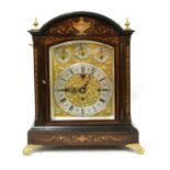 An Edwardian inlaid mahogany three-train bracket clock,