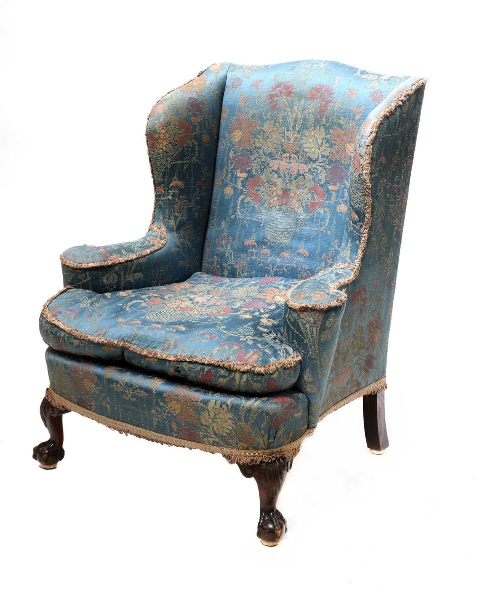 A silk upholstered wingback armchair,