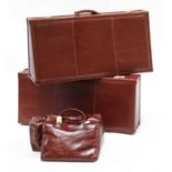 A set of three 'bespoke luggage' leather cases,