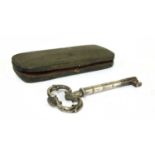 A large white metal and steel key,