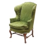 A walnut framed wingback armchair