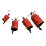 Four graduated red painted cow bells,