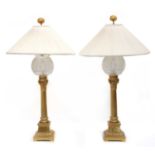 A pair of gilt brass and glass table lamps,