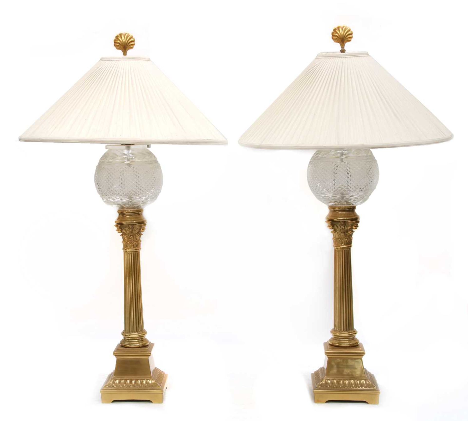 A pair of gilt brass and glass table lamps,