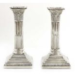 A pair of Victorian silver Corinthian column candlesticks,