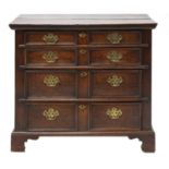 A transitional oak chest of drawers