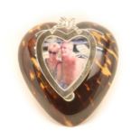A silver and Tortoishell heart shaped desk paper clip