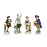 A pair of Sitzendorf porcelain figures of a lady and gentleman in traditional costume,