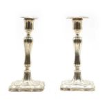 A pair of Edwardian silver candlesticks,