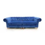 A contemporary blue velvet upholstered button back Chesterfield sofa,