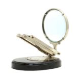 An opticians table mounted magnifier,