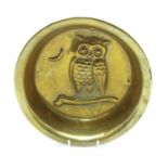 An Arts and Crafts circular deep brass tray with owl on a branch motif and crescent moon,