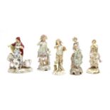 A pair of Berlin porcelain figures of a man and woman in traditional floral decorated garments,