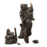 A 19th century Japanese hardwood carved figure of an elder with a staff,