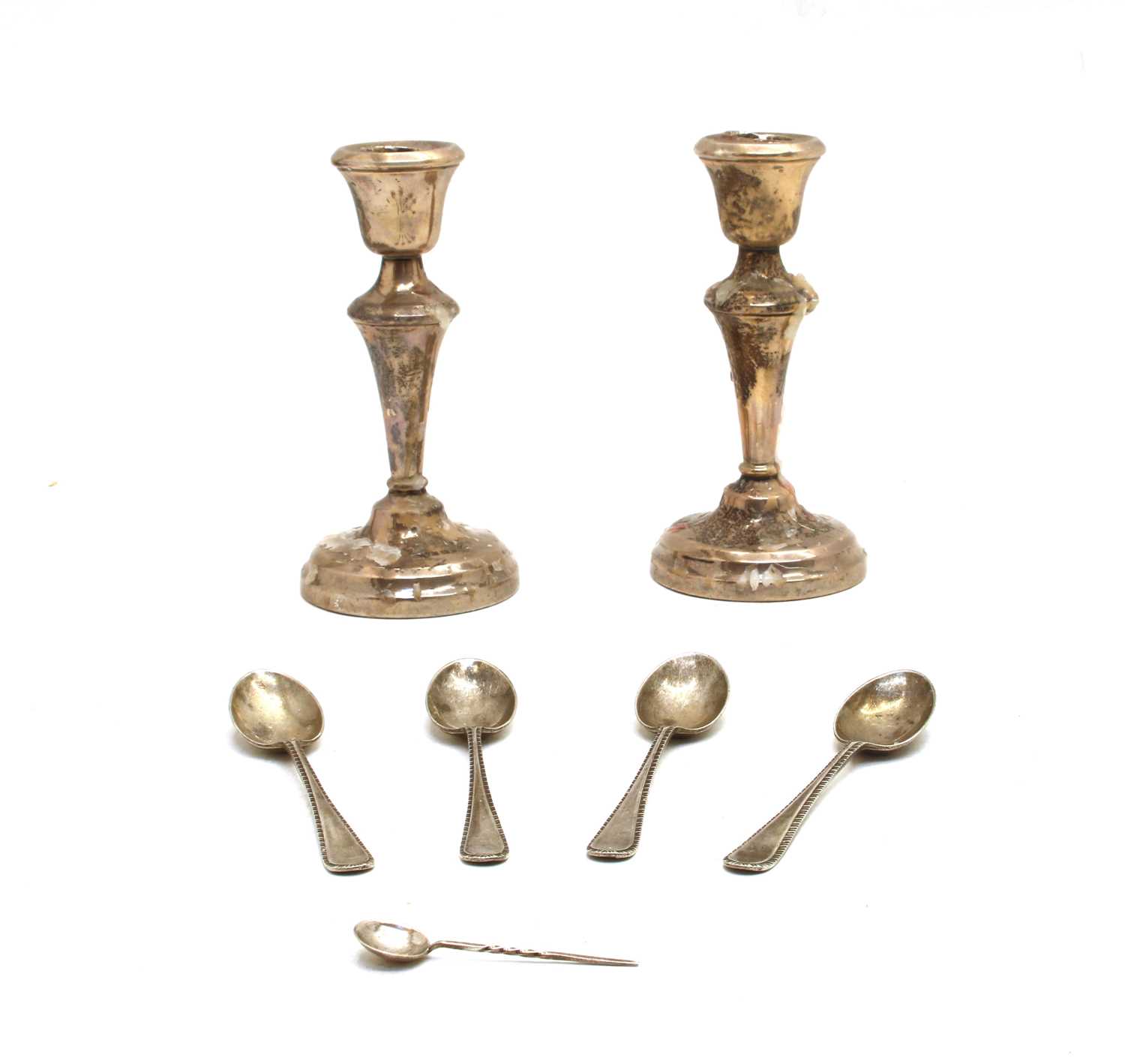 A pair of silver candlesticks with knopped tapering stem,