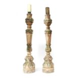 A pair of carved wood candle stands,