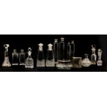 A collection of various silver topped perfume bottles and dressing jars,