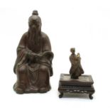 A Japanese bronze figure of a seated elder,