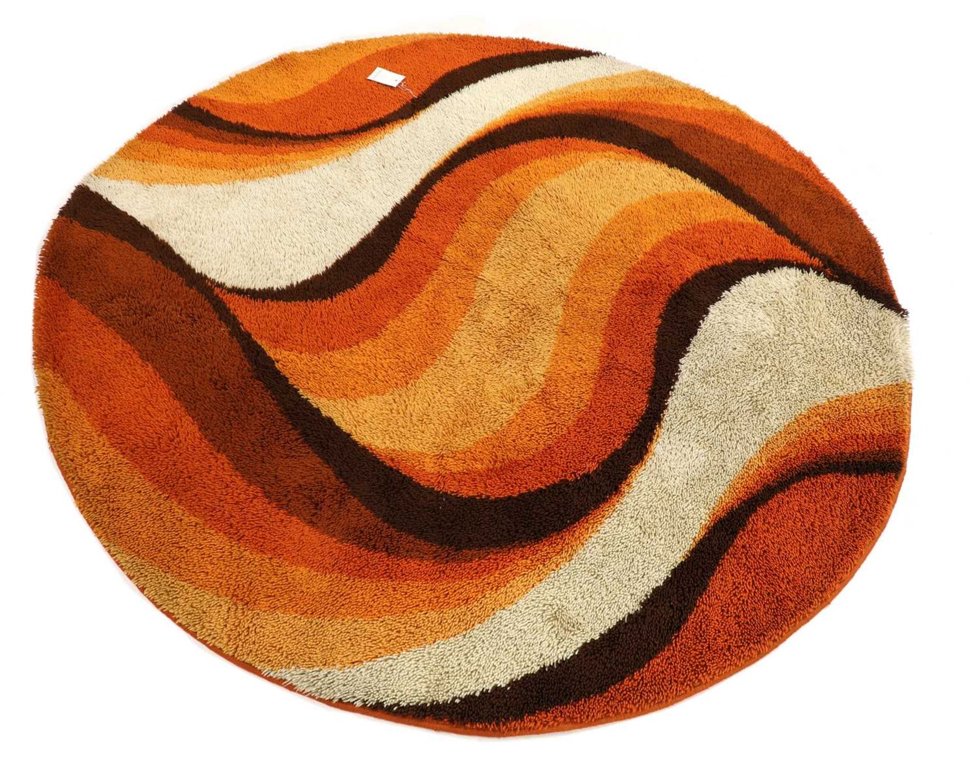 An orange, brown and beige wool carpet,