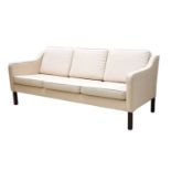 A Danish cream fabric three-seater settee,