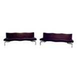 A pair of purple upholstered settees,