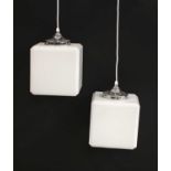 A pair of cube-shaped opaline glass pendants,