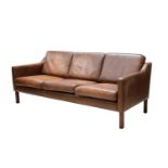 A Danish brown leather three-seater settee,