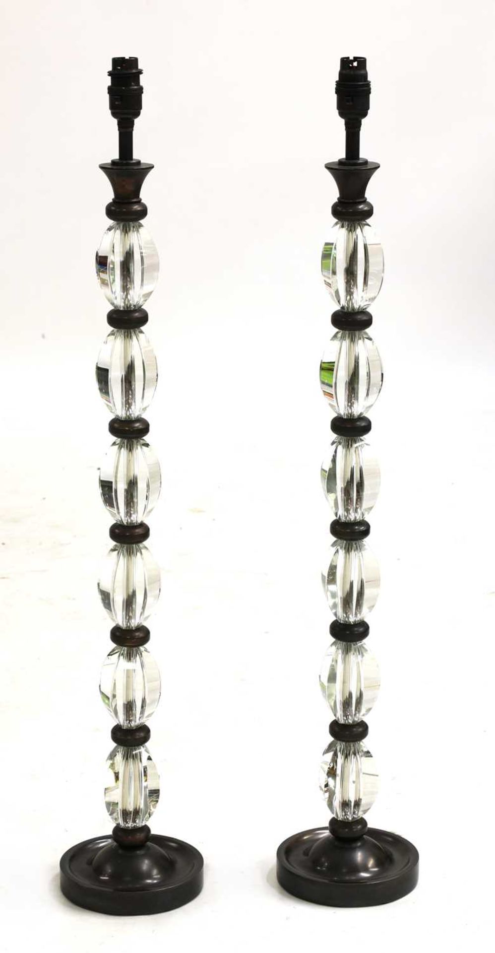 A pair of modern glass-mounted table lamps,