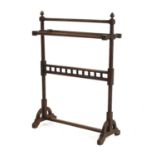 An Arts and Crafts walnut towel rail,