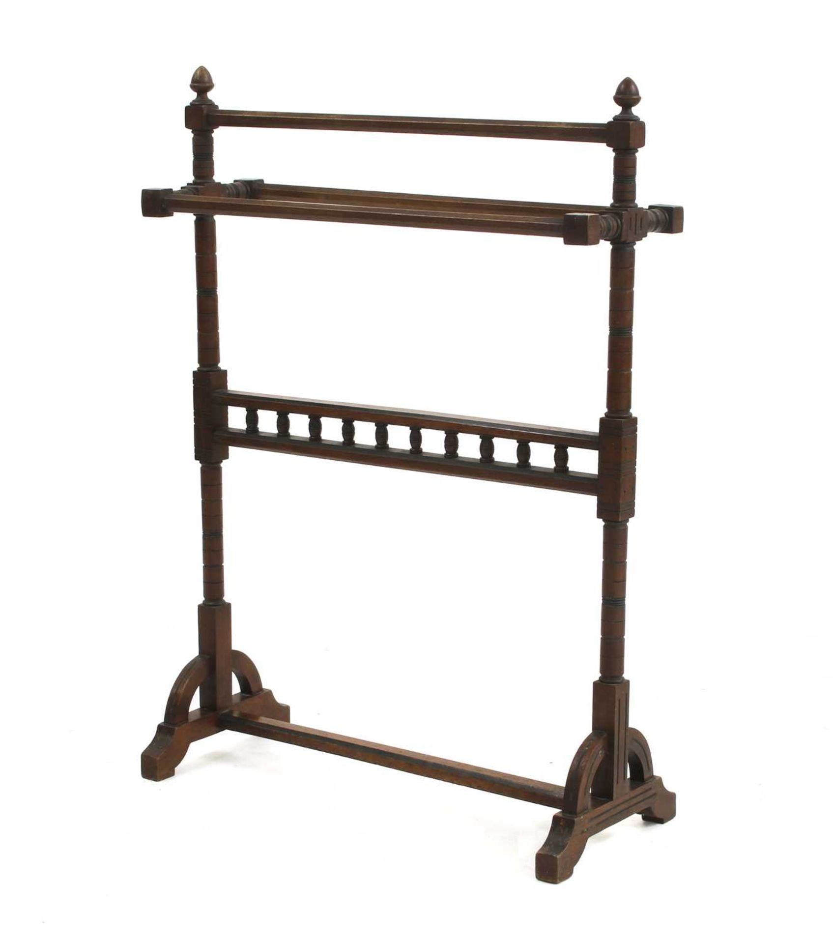 An Arts and Crafts walnut towel rail,