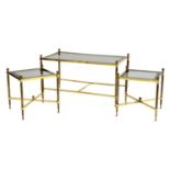 A nest of three brass tables,
