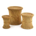 Three sisal and cane graduated stools,