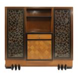 An unusual teak and ebony breakfront buffet,