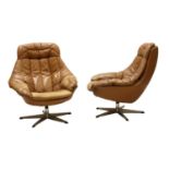 A pair of leather lounge chairs,