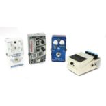 A group of four guitar effects pedals,