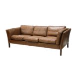 A Danish brown leather three-seater settee,
